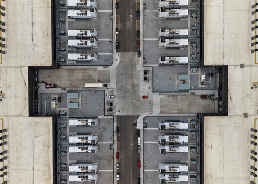 Aerial view of a large industrial facility with rows of cooling units on the roof, parking areas, and concrete surfaces in South Bend, Indiana, United States.