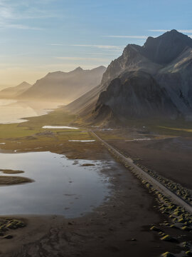 Aerial view of the Viking Village film set nestled at the base of dramatic mountains near the coast in Hofn, Sveitarfelagid Hornaf, Iceland.