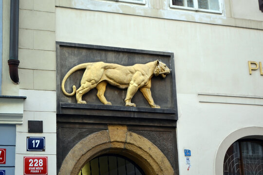 PRAGUE, CZECH REPUBLIC - JUNE, 29, 2026. Golden tiger relief above arched entrance of Prague tavern facade for travel banner and architectural background