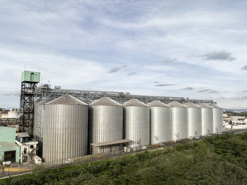 Aerial view of a large industrial grain silo complex with metallic cylindrical storage tanks and surrounding infrastructure in Nairobi, Nairobi County, Kenya.