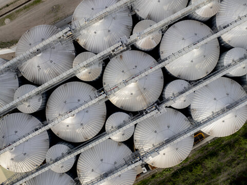 Aerial view of industrial grain storage silos with metallic ribbed roofs arranged in a grid pattern at a facility in Nairobi, Nairobi County, Kenya.