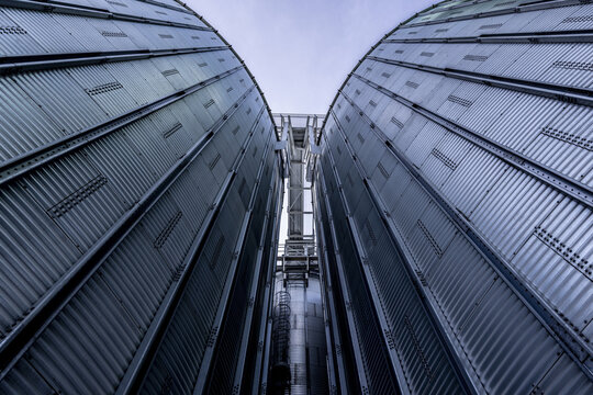 View of industrial metal grain silos with corrugated surfaces and vertical lines rising against the sky in Nairobi, Nairobi County, Kenya.