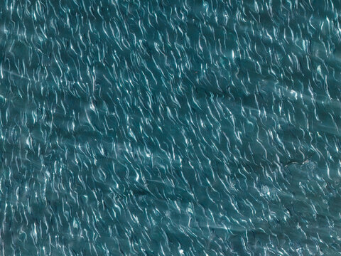 Aerial view of the rippling blue water surface of the Bering Sea near Unalaska, Alaska, United States.