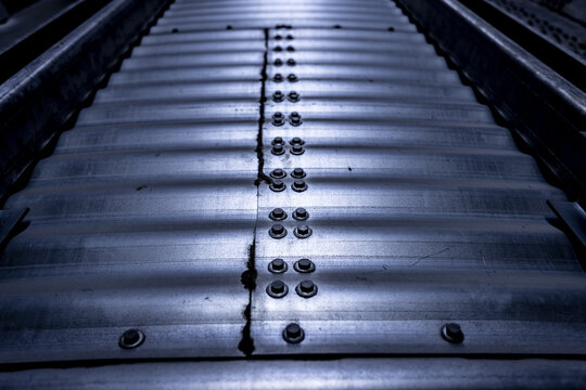 View of a corrugated metal surface with a central seam secured by industrial bolts in Nairobi, Nairobi County, Kenya.