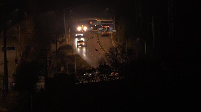 City night view of traffic lights at the entrance of highway underpass