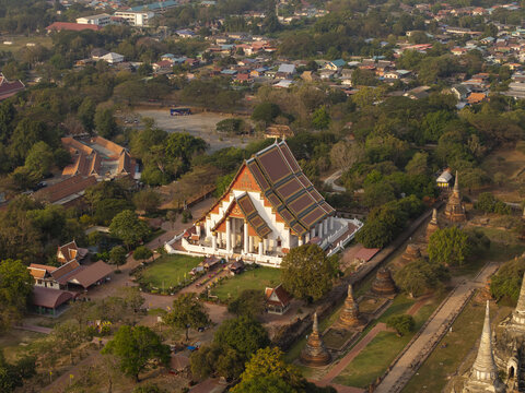 Aerial view of Wiharn Phra Mongkhon Bophit temple with its tiered roof, surrounded by ancient stupas in Amphoe Phra Nakhon Si Ayutthaya, Chang Wat Phra Nakhon, Thailand.
