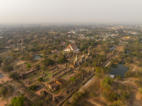 Aerial view of the ancient ruins of Wat Phra Si Sanphet with iconic stupas and lush greenery in Phra Nakhon Si Ayutthaya District, Phra Nakhon Si Ayutthaya, Thailand.
