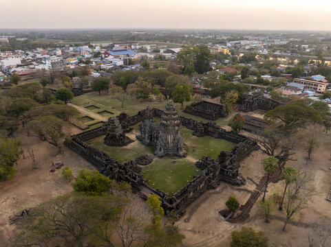 Aerial view of Phimai Historical Park featuring ancient Khmer temple ruins surrounded by trees with the town of Nai Mueang in the background, Nai Mueang, Nakhon Ratchasima, Thailand.