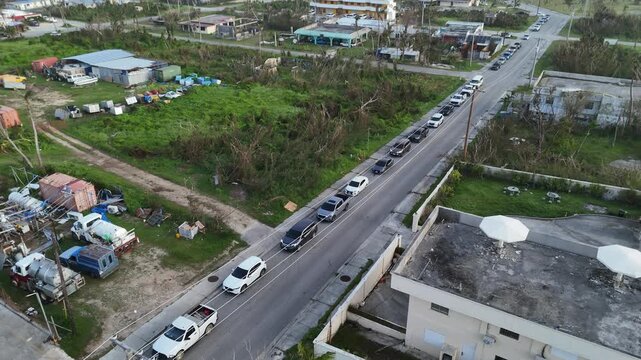 San Jose, Northern Mariana Islands - 07 July 2026: Aerial view of long vehicle queues at a gas station following fuel shortages caused by super typhoon Bavi.