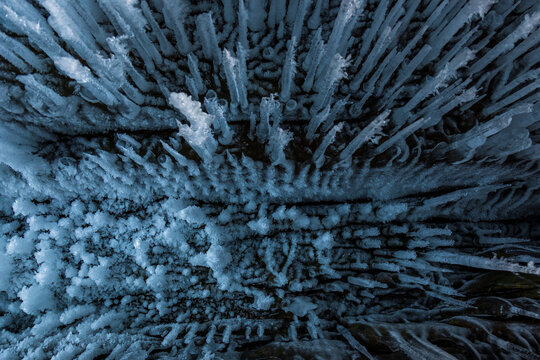 View of intricate ice formations and icicles hanging inside a frozen cave at Lake Baikal in Khuzhir, Irkutsk Oblast, Russia.