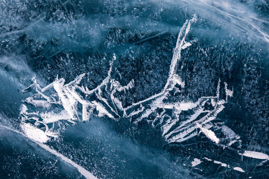 View of intricate ice patterns and deep cracks on the surface of Lake Baikal in Khuzhir, Irkutsk Oblast, Russia.