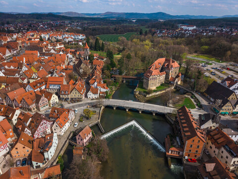 Aerial view of the historic Wenzelschloss castle on the Pegnitz river, surrounded by traditional half-timbered houses and red-tiled rooftops in Lauf an der Pegnitz, Bavaria, Germany.