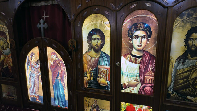 Coober Pedy, South Australia, Australia - 15 January 2025: View of the iconostasis inside the Serbian Orthodox Church, featuring illuminated religious icons of saints and Christ on a wooden structure.
