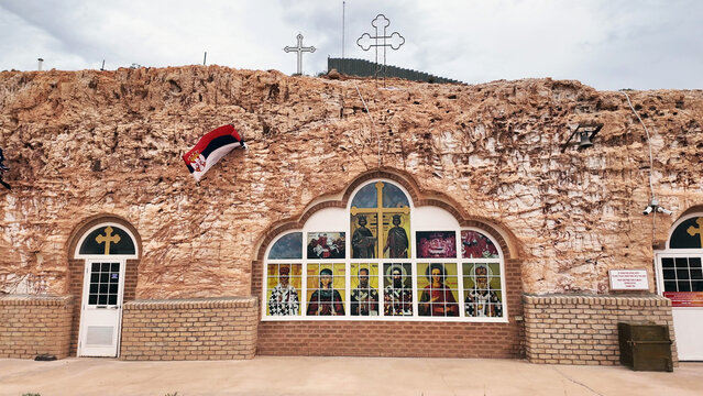 Coober Pedy, Australia - 15 January 2025: View of the underground Serbian Orthodox Church carved into the sandstone rock face with religious icons and crosses.