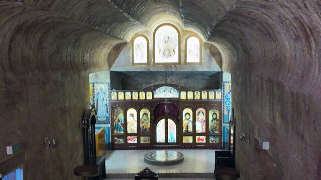 Coober Pedy, South Australia, Australia - 15 January 2025: View of the underground Serbian Orthodox Church, featuring carved rock walls and an ornate iconostasis.