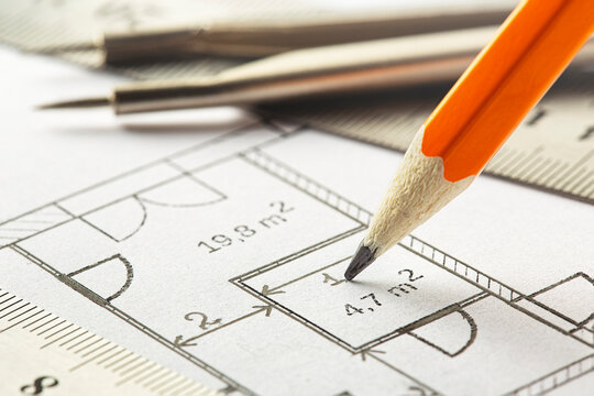 pencil and on blueprints. Concept of industrial and real estate construction.