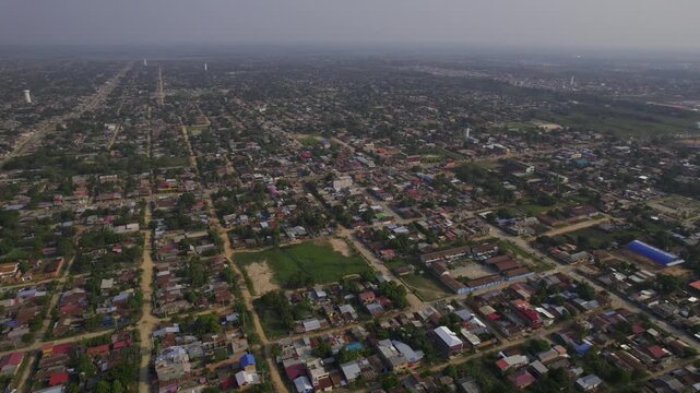 Aerial view of the city of Pucallpa, showing dense residential housing, street grids, and surrounding tropical landscape in Pucallpa, Ucayali, Peru.