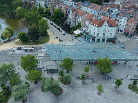 Ixelles, Bruxelles, Belgium - 03 July 2026: Aerial view of Place Eugene Flagey with its modern glass canopy, surrounding historic buildings, and nearby pond.