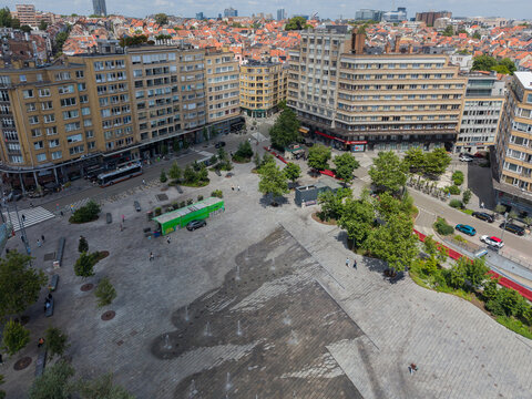 Ixelles, Belgium - 03 July 2026: Aerial view of Place Eugene Flagey, featuring the paved square with fountains, surrounded by historic buildings, trees, and urban streets.