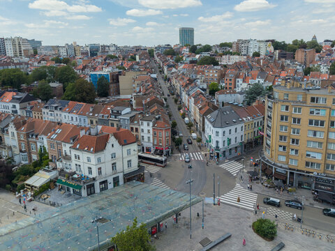 Ixelles, Belgium - 03 July 2026: Aerial view of Place Eugene Flagey, featuring the urban square, historic buildings with red-tiled roofs, city streets, and a bus.