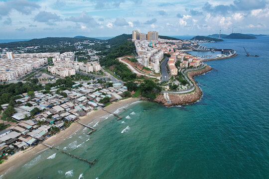Aerial view of the colorful Mediterranean style coastal town of Sunset Town with vibrant buildings, winding roads, and turquoise waters along the coastline of Phu Quoc, Kien Giang, Vietnam.