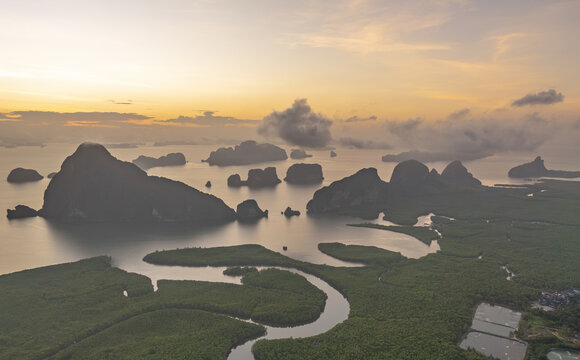 Aerial view of the limestone karsts and mangrove forests near Hin Rom Pier at sunset in Tambon Khlong Khian, Chang Wat Phang-nga, Thailand.