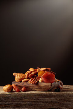 Dried fruits and nuts on a old wooden table.