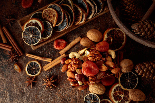 Dried fruits and nuts on a brown vintage background.