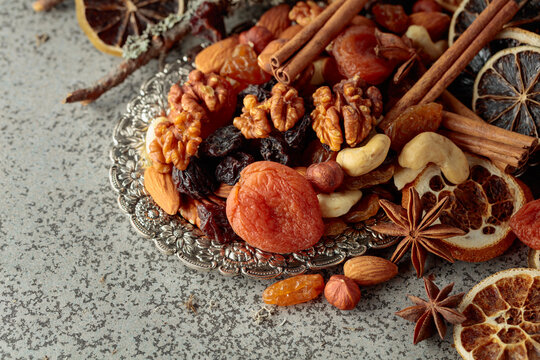 Dried fruits and nuts on a silver try.