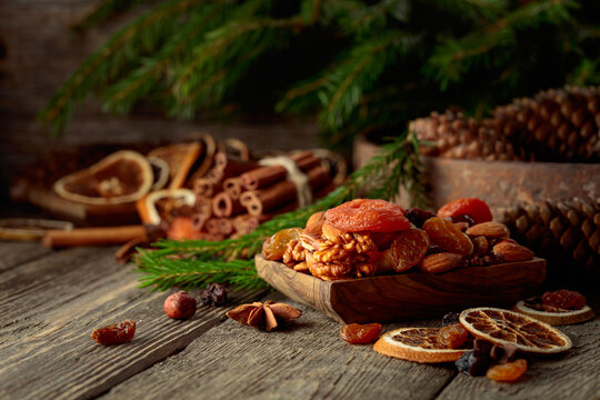 Dried fruits and nuts on an old wooden table.