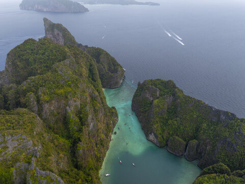 Aerial view of Pi Leh Bay featuring turquoise waters, limestone cliffs, and long-tail boats in Tambon Ao Nang, Chang Wat Krabi, Thailand.