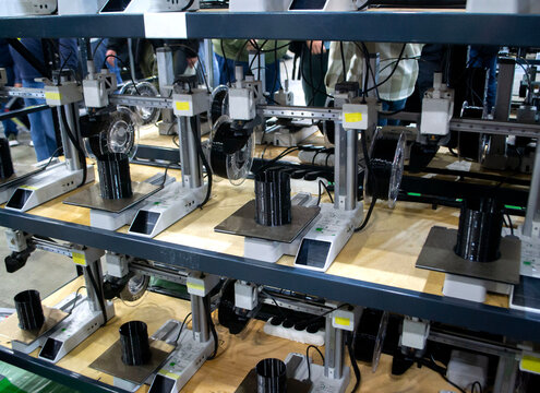 3D printer. Many 3D printers printing object close-up. 3D printer printing black