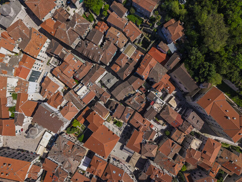 Aerial view of the historic Old Town of Kotor with its dense cluster of terracotta-tiled rooftops, narrow stone streets, and ancient architecture in Kotor, Kotor Municipality, Montenegro.