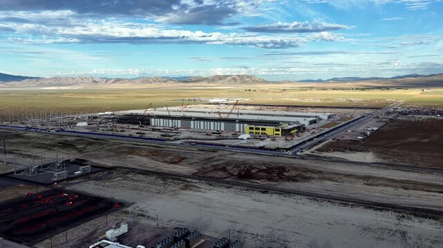 Aerial view of the Meta Data Center construction site featuring large industrial buildings, cranes, and surrounding desert landscape in Eagle Mountain, Utah, United States.