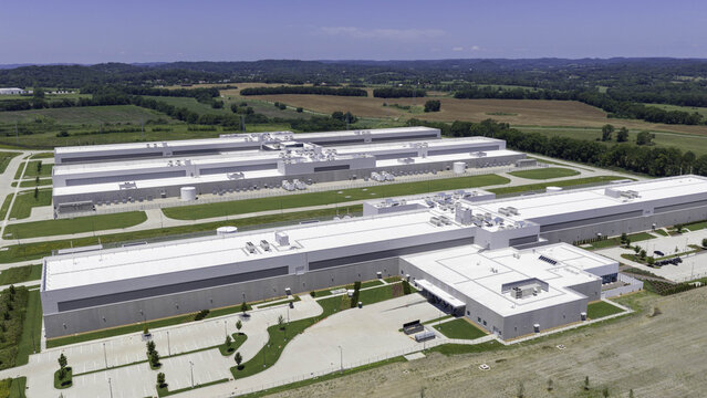 Aerial view of the Meta Data Center featuring large industrial buildings with white roofs surrounded by expansive green fields and rural landscape in Gallatin, Tennessee, United States.