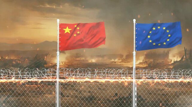 Chinese and European Union flags blowing in wind with barbed wire fence before burning war zone ruins.