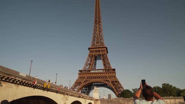 Eiffel Tower seen from a stone bridge over the Seine in Paris