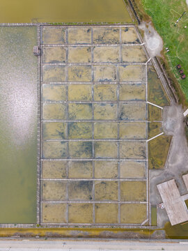Aerial view of the Salt Museum in Pomorie, featuring geometric salt pans with shallow water and wooden walkways, Pomorie, Burgas, Bulgaria.