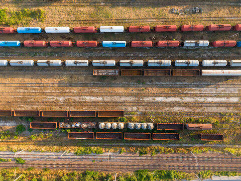 Aerial view of freight trains with colorful cargo containers parked on multiple rail tracks in the southern industrial zone of Varna, Varna, Bulgaria.