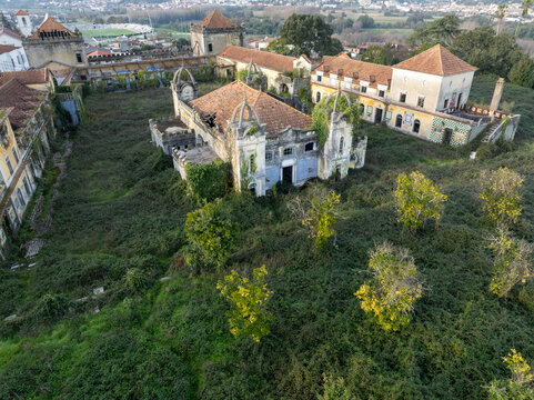 Aerial view of the abandoned Quinta Conde de Sucena estate with overgrown vegetation and historic architecture in Borralha, Aveiro, Portugal.