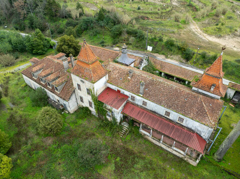 Aerial view of Ruinas Quinta da Zombaria with weathered terracotta rooftops and stone walls, Uniao das freguesias de Antuzede e Vil de Matos, Coimbra, Portugal.