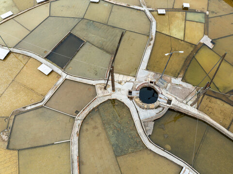 Aerial view of Salinas de Rio Maior, featuring the historic salt pans with their characteristic wooden structures and water-filled basins in Rio Maior, Santarem, Portugal.