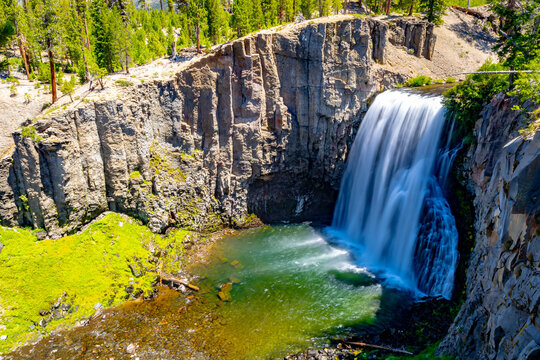 Rainbow Falls dropping over volcanic cliff into pool at Devils Postpile National Monument California