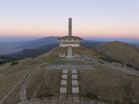 Aerial view of the Buzludzha Monument standing on a mountain peak at sunset in Stara Zagora, Bulgaria.