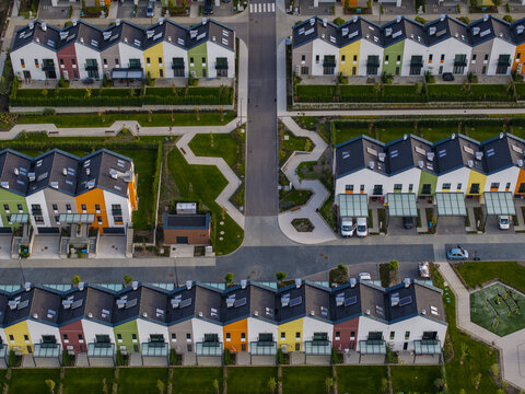 Aerial view of Residential Park Lozen featuring rows of colorful modern townhouses with manicured green lawns and paved walkways in Sofia, Sofia City Province, Bulgaria.