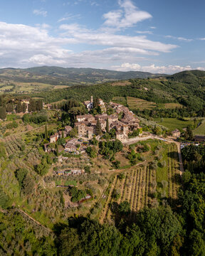 Aerial view of the historic village of Montefioralle, surrounded by lush vineyards, olive groves, and rolling hills in the heart of the Tuscan countryside, Montefioralle, Tuscany, Italy.