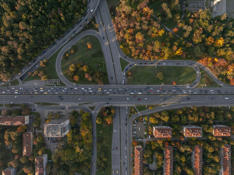 Aerial view of a busy highway interchange surrounded by autumn trees and residential buildings in Sofia, Sofia City Province, Bulgaria.