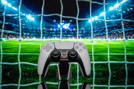 August 6, 2026, Odessa, Ukraine.  Sony PS5 DualSense controller with illuminated football stadium net back