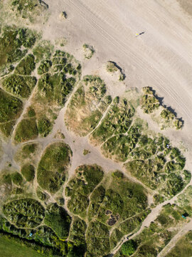 Aerial view of the sandy dunes and coastal landscape at Malahide Beach with patches of green vegetation and walking paths Malahide, County Dublin, Ireland.