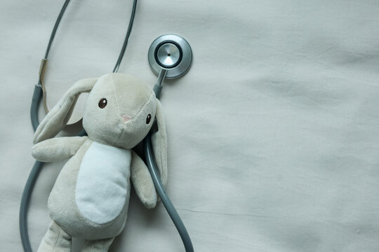 close up cute and lovely toddler rabbit with stethoscope on beige color background represent about children health checkup and pediatrics for childhood healthcare concept